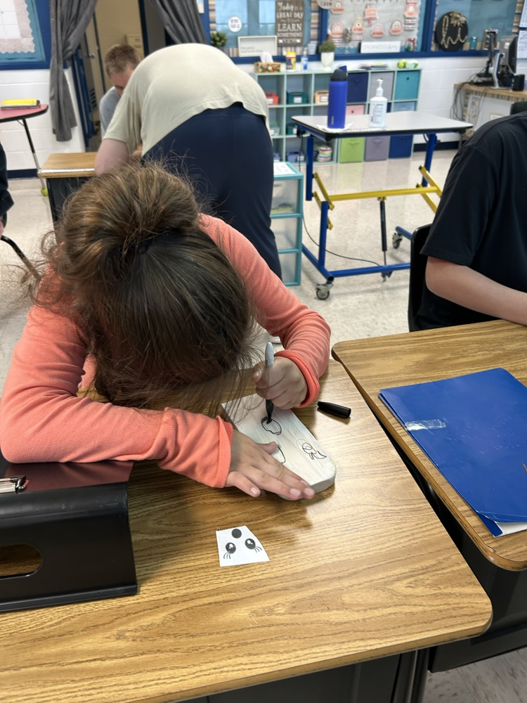 student drawing ghost face