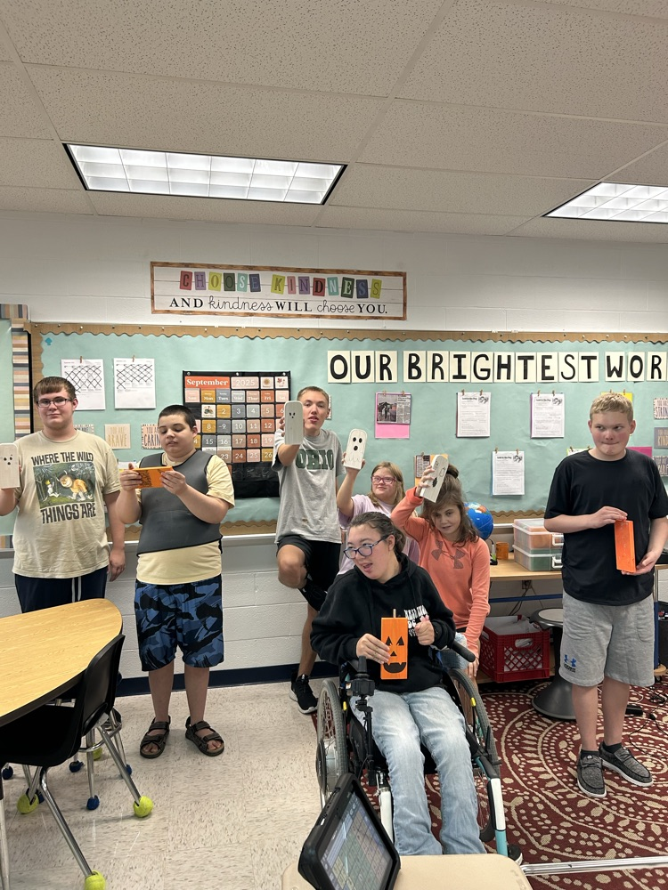 students with their ghosts and pumpkins
