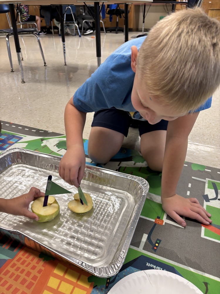 student playing with apple boat