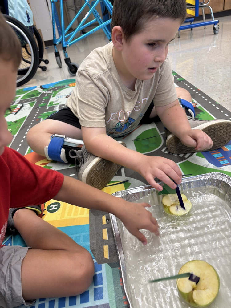 student playing with apple boat