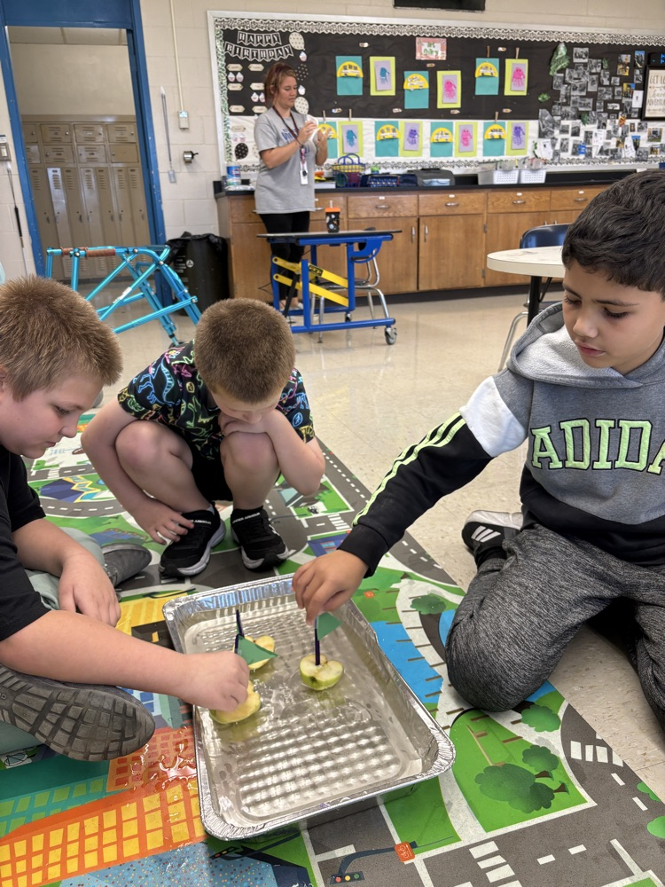 students playing with apple boat