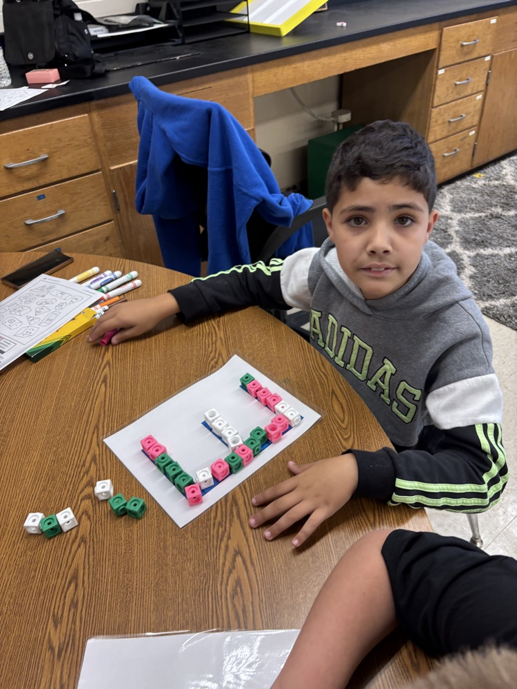 students building letters with blocks