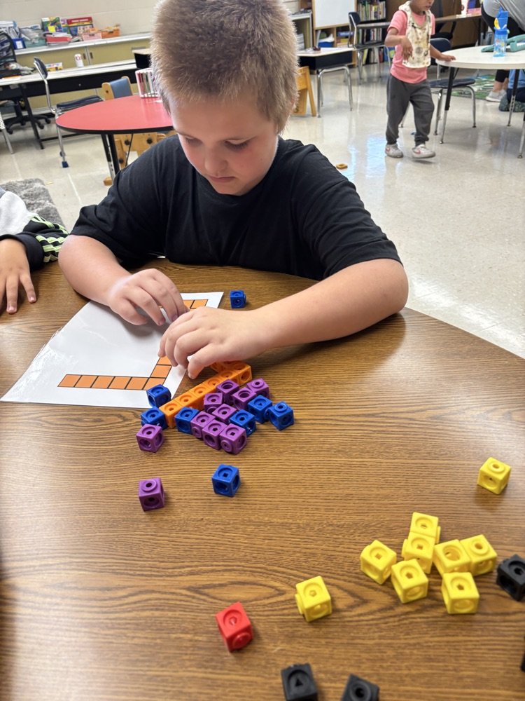 students building letters with blocks