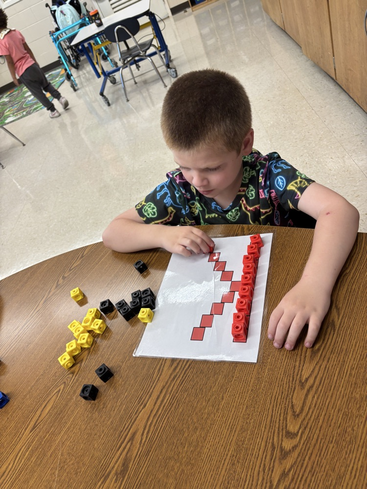 students building letters with blocks
