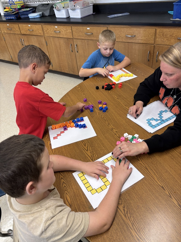 students building letters with blocks