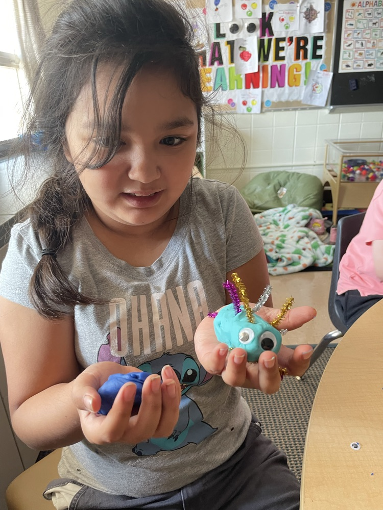 student with playdoh bugs