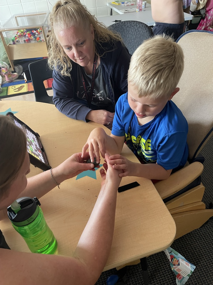 student with playdoh bug