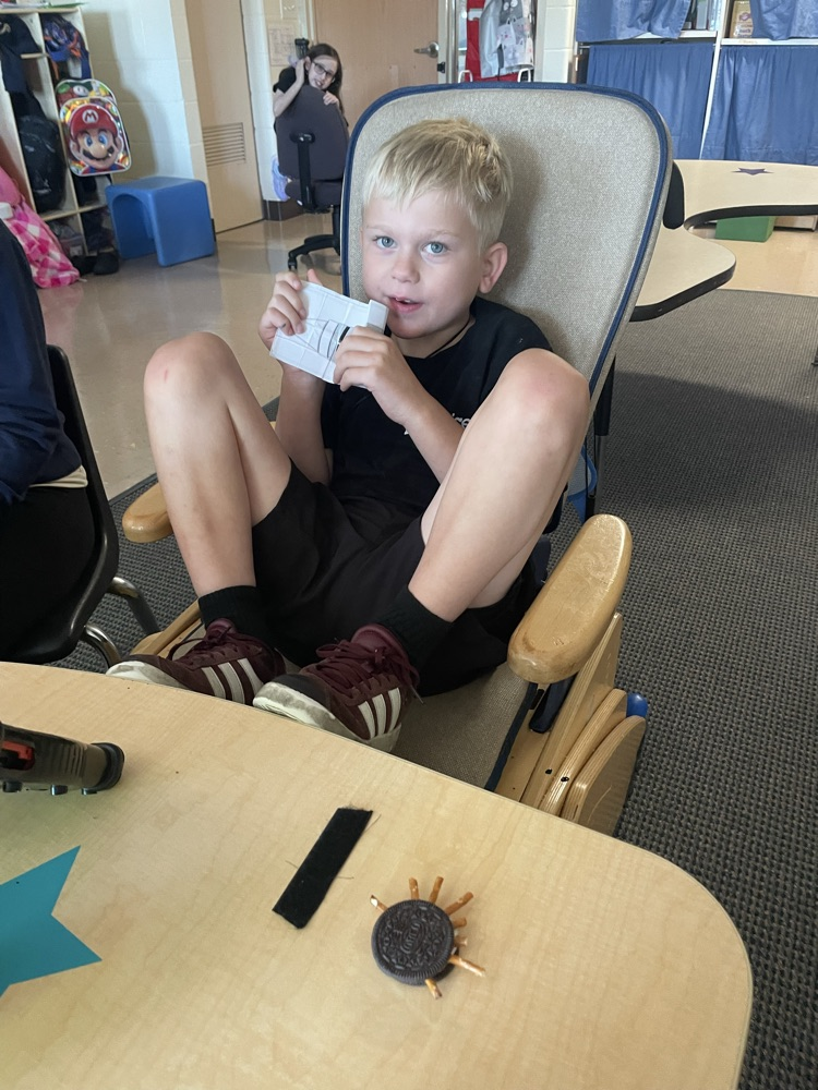 student making Oreo spiders
