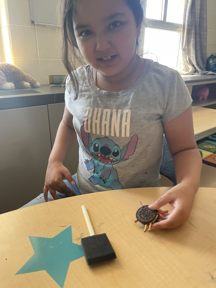student making Oreo spiders