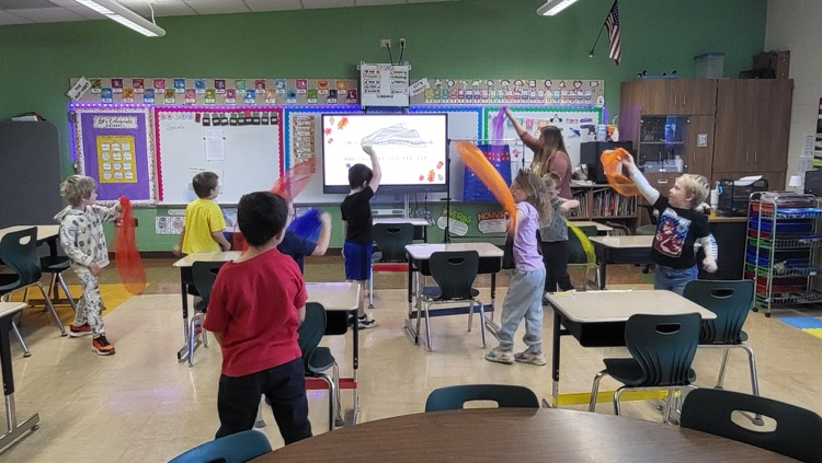 students dancing with scarves