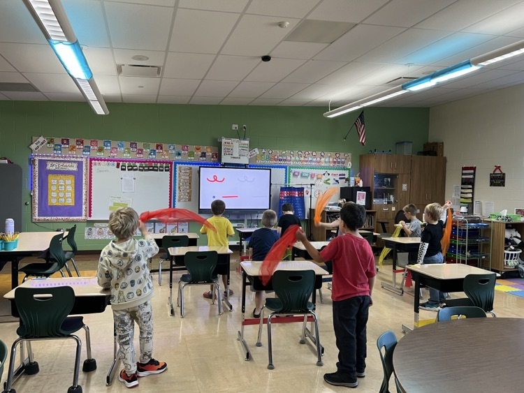 students dancing with scarves