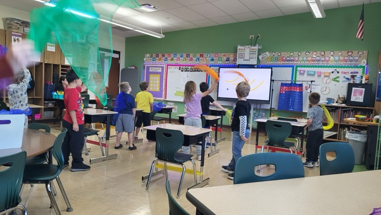 students dancing with scarves