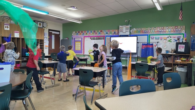 students dancing with scarves