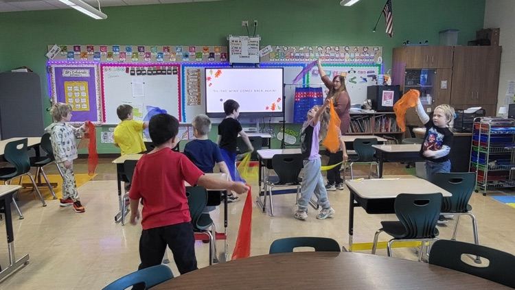students dancing with scarves