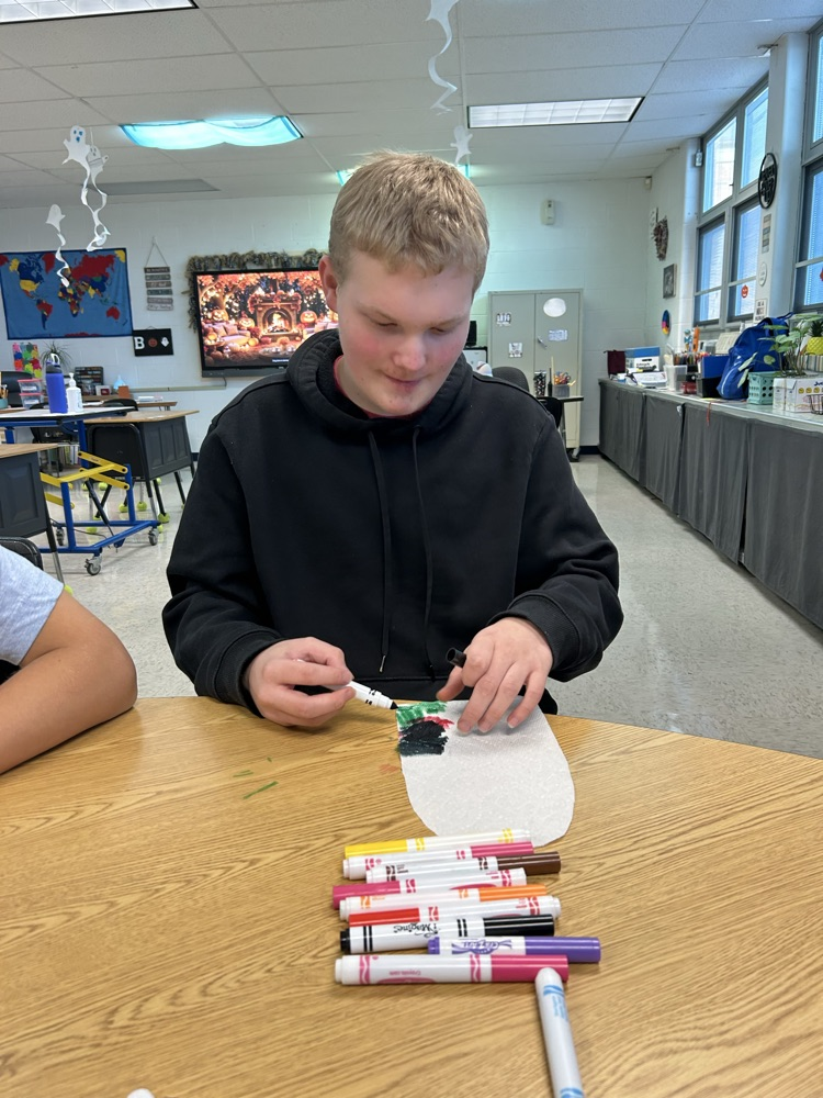 students coloring ghosts