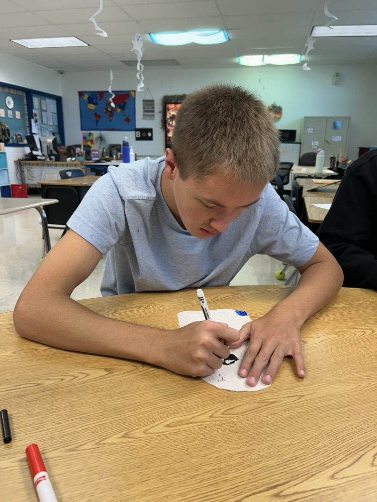 students coloring ghosts
