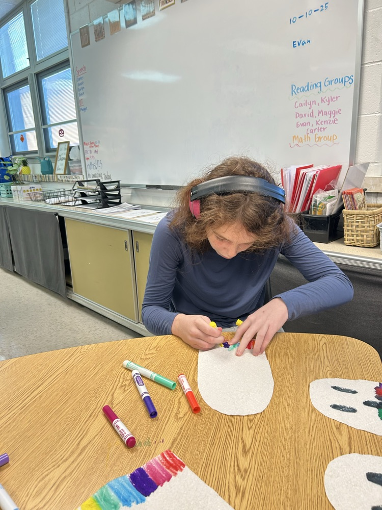 students coloring ghosts