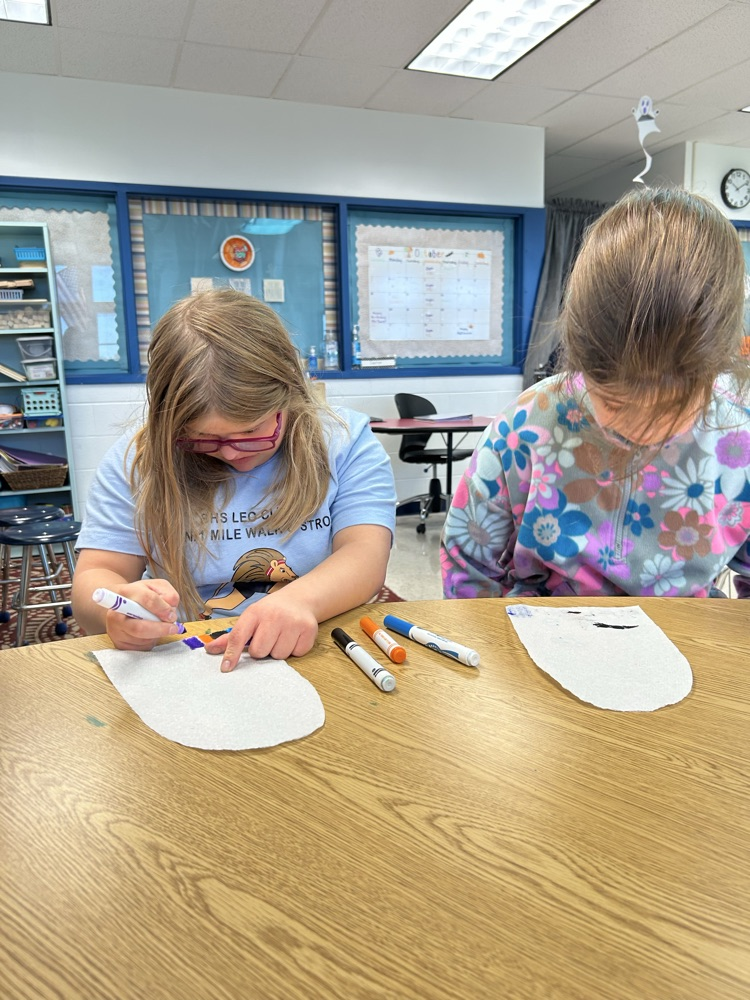 students coloring ghosts
