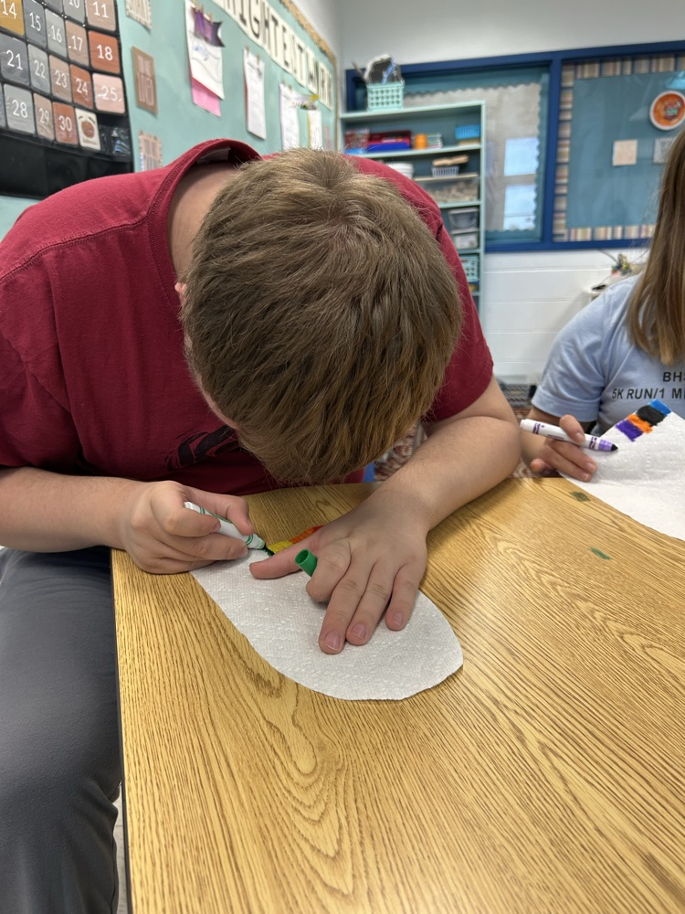 students coloring ghosts