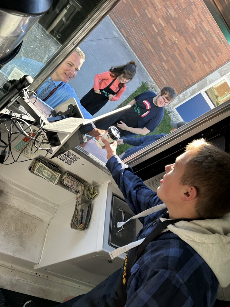 student serving coffee