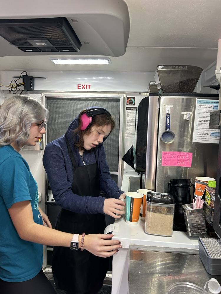 student serving coffee