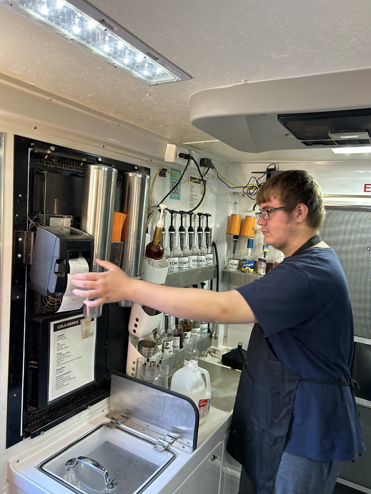 student serving coffee