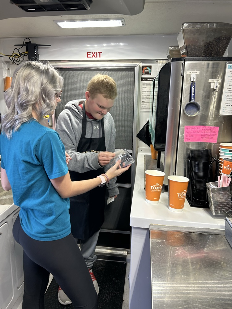 student serving coffee