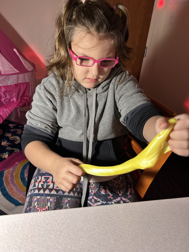 student playing with slime