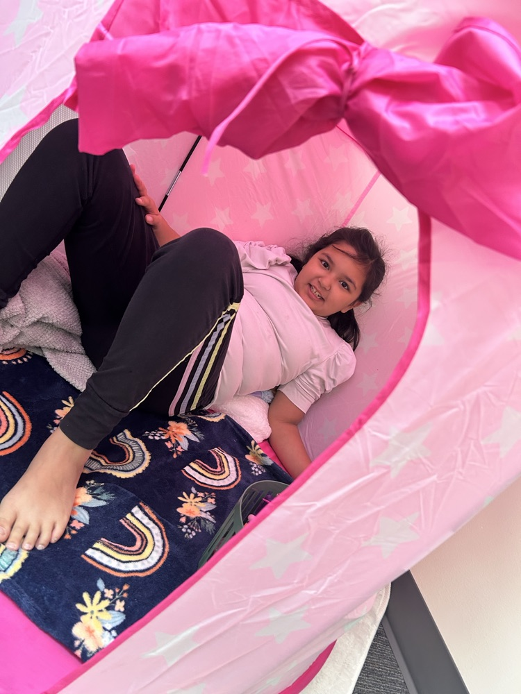 student sitting in tent