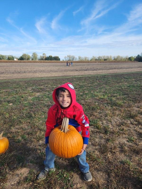 student with pumpkin