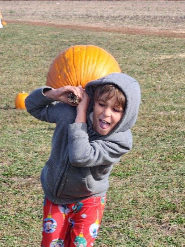 student with pumpkin