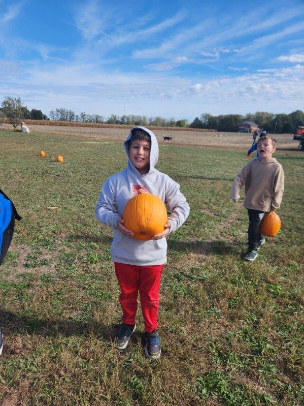 student with pumpkin