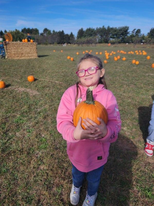 student with pumpkin