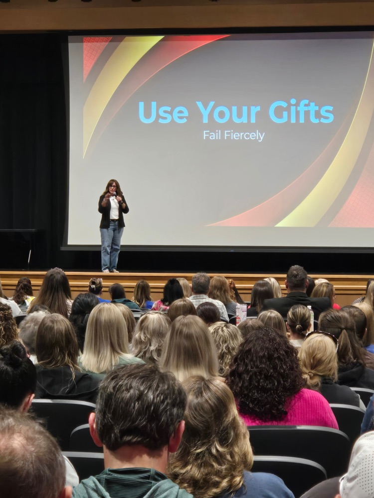 Carrie Sanchez speaking in front of stafdstaff
