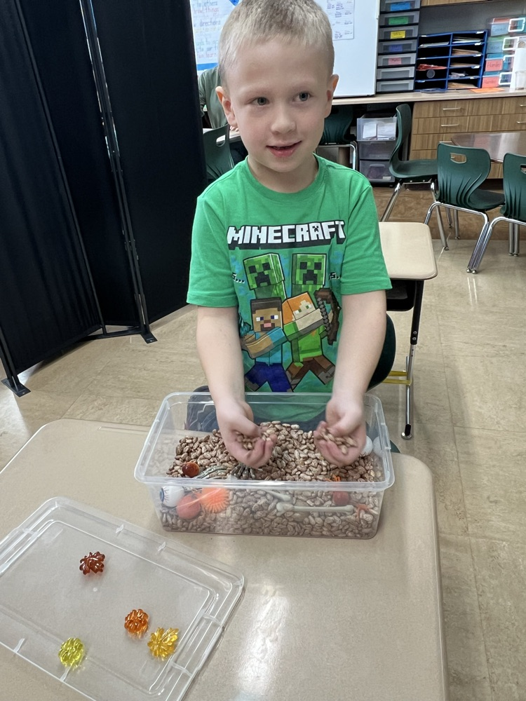 student playing in sensory bin