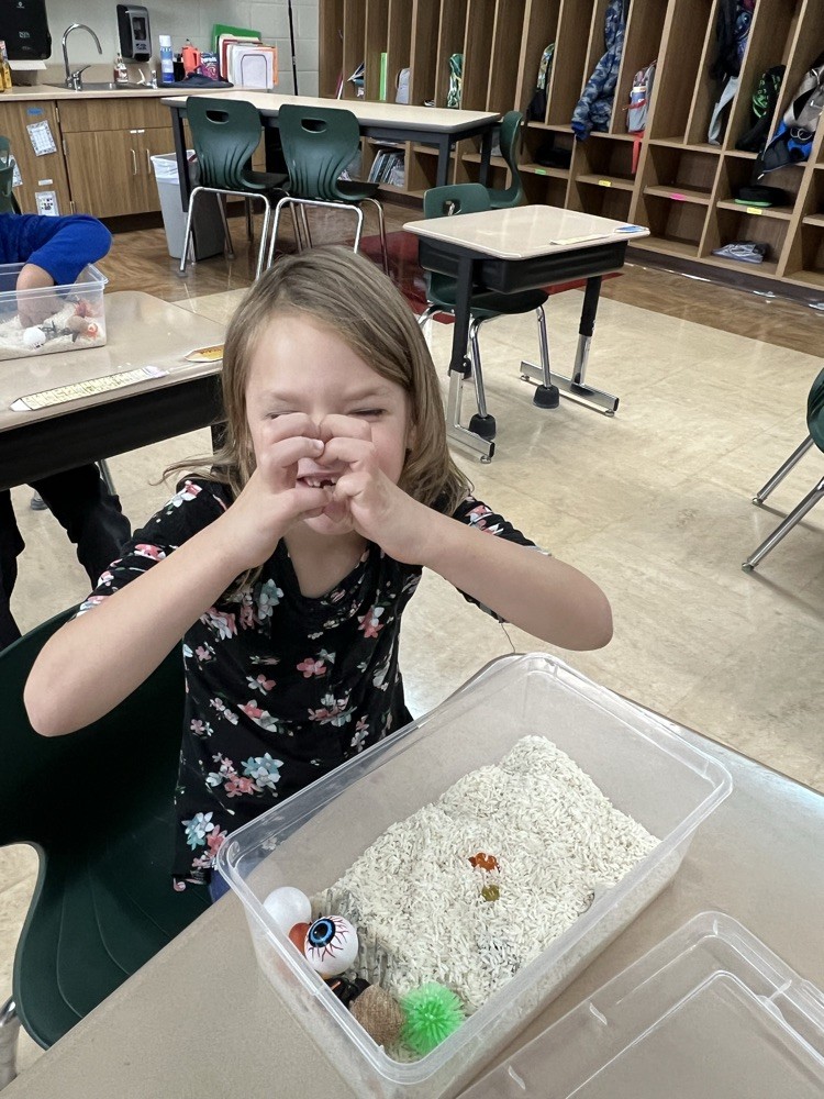 student playing in sensory bin