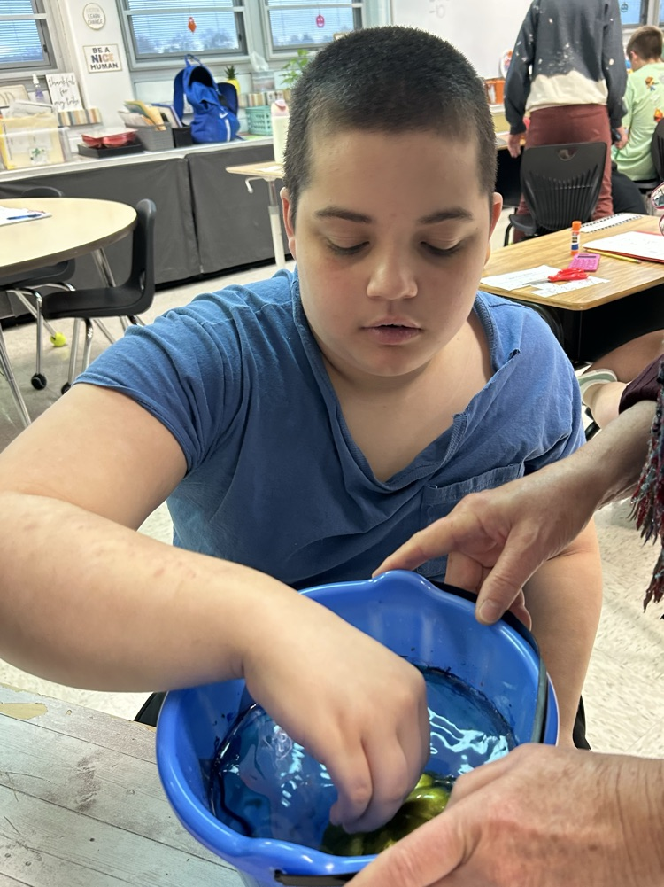 student painting pumpkins