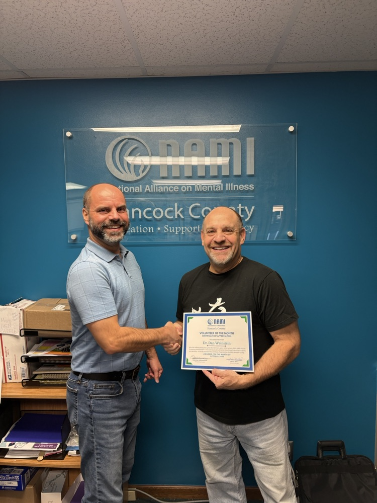 man shaking another man’s hand