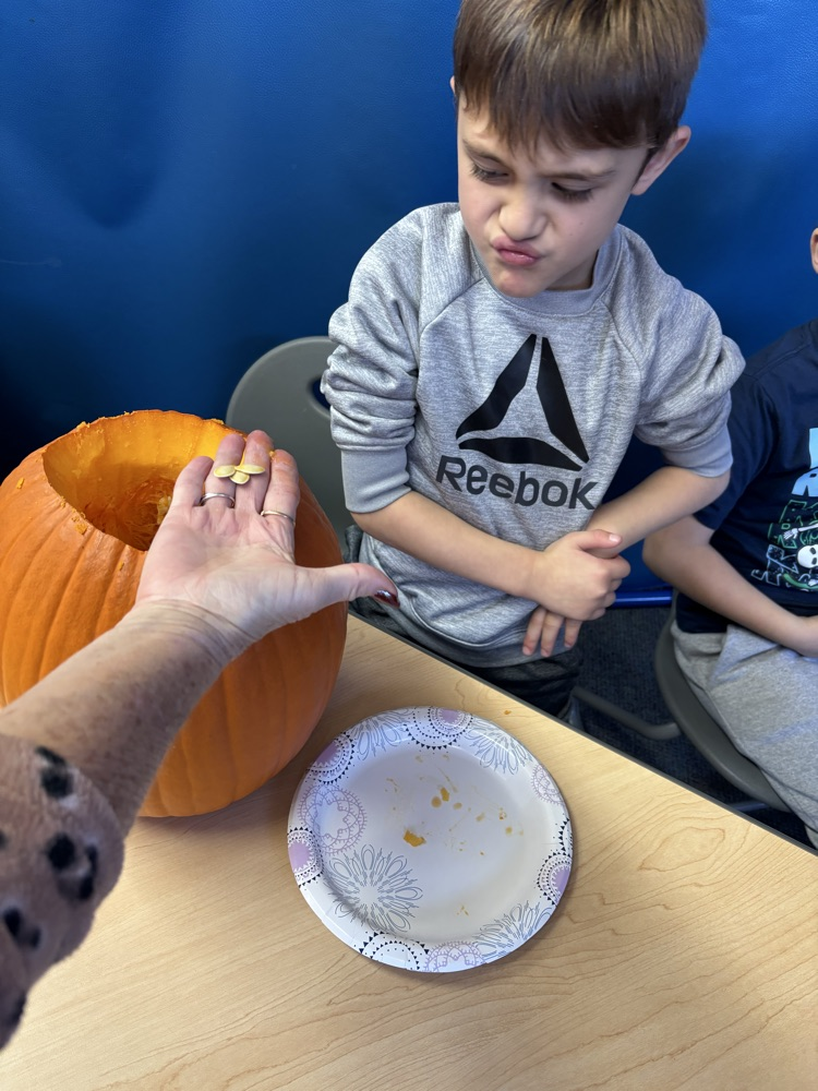 students carving pumpkins