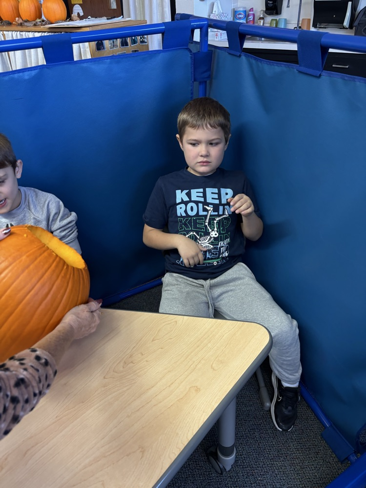students carving pumpkins