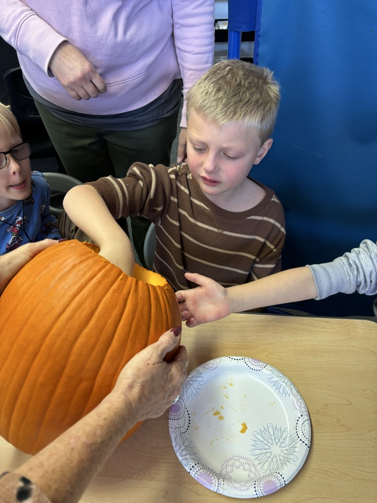 students carving pumpkins