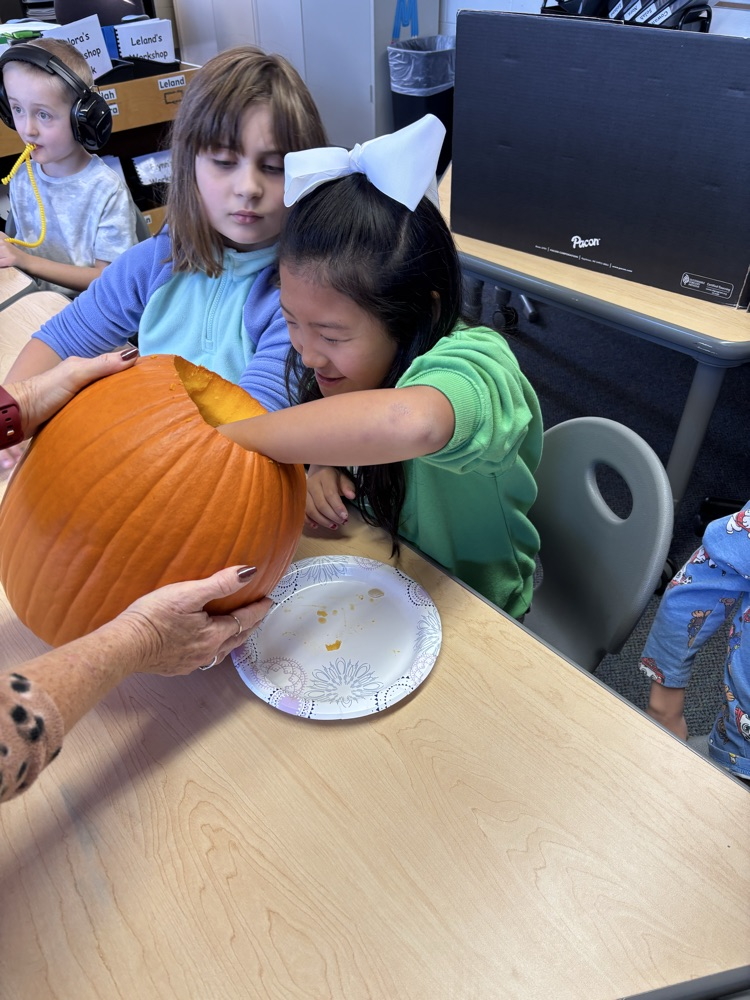 students carving pumpkins