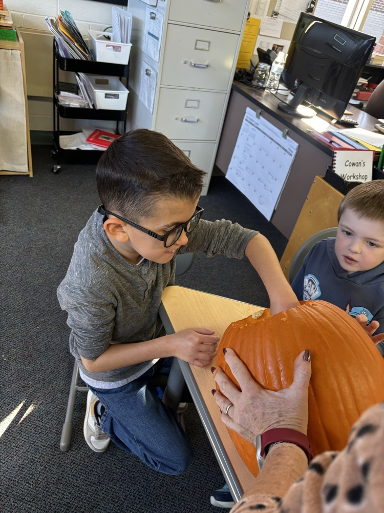 students carving pumpkins