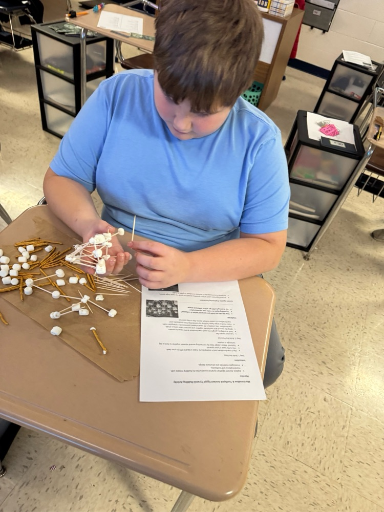 student building with pretzels, sticks and marshmallows