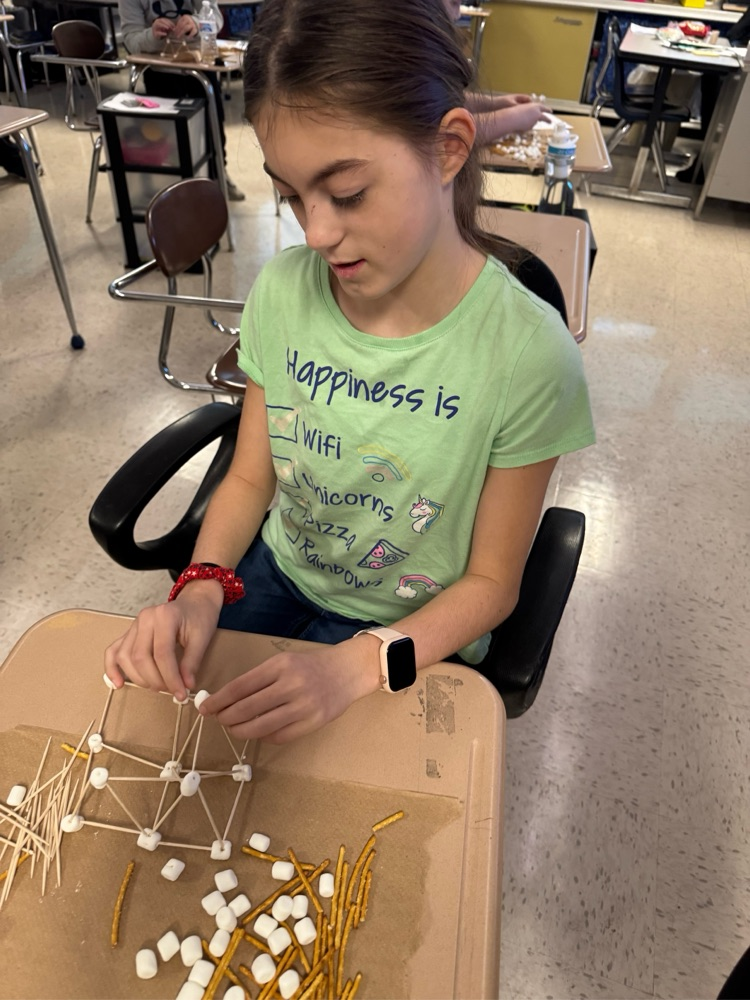 student building with pretzels, sticks and marshmallows
