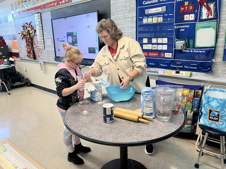 student measuring flour