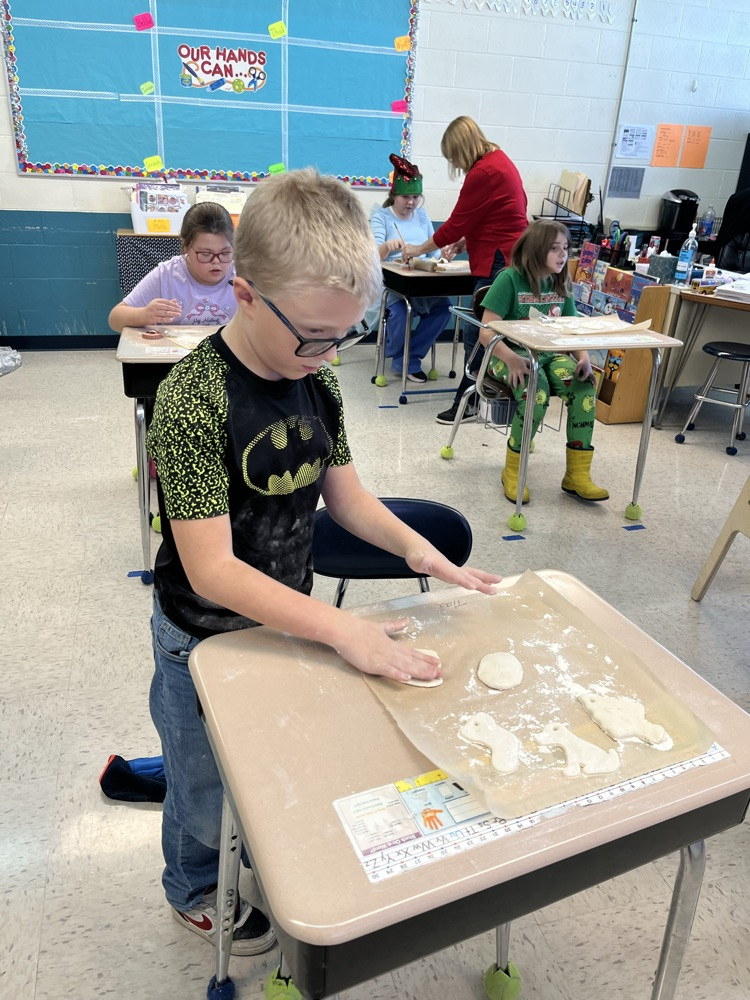 students cutting out shapes