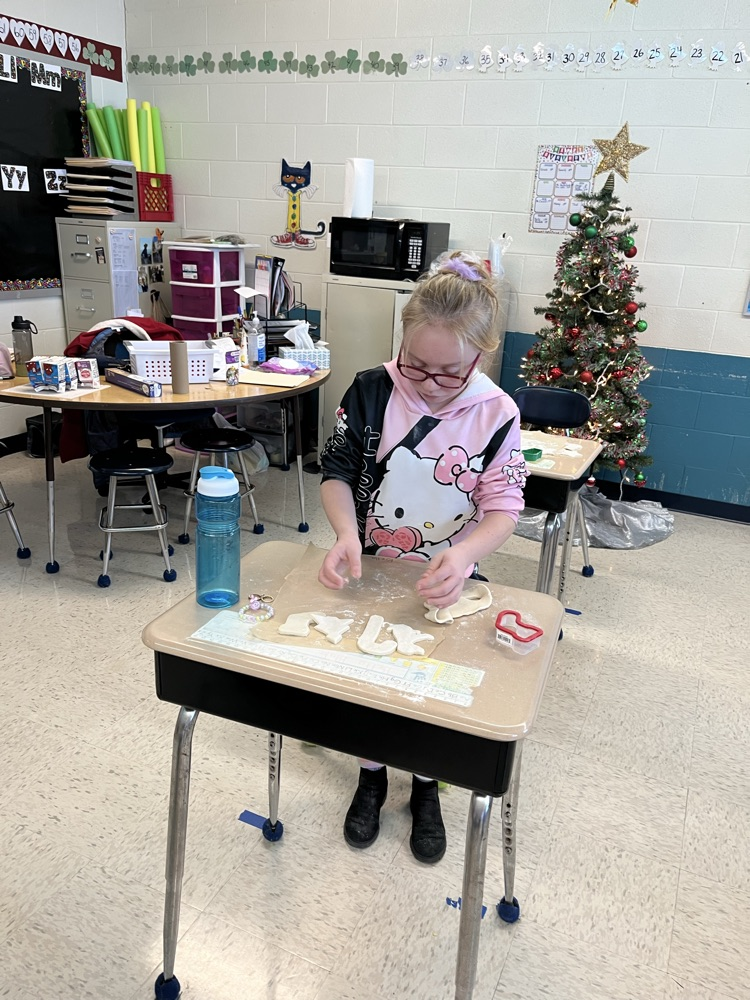 student cutting out shapes