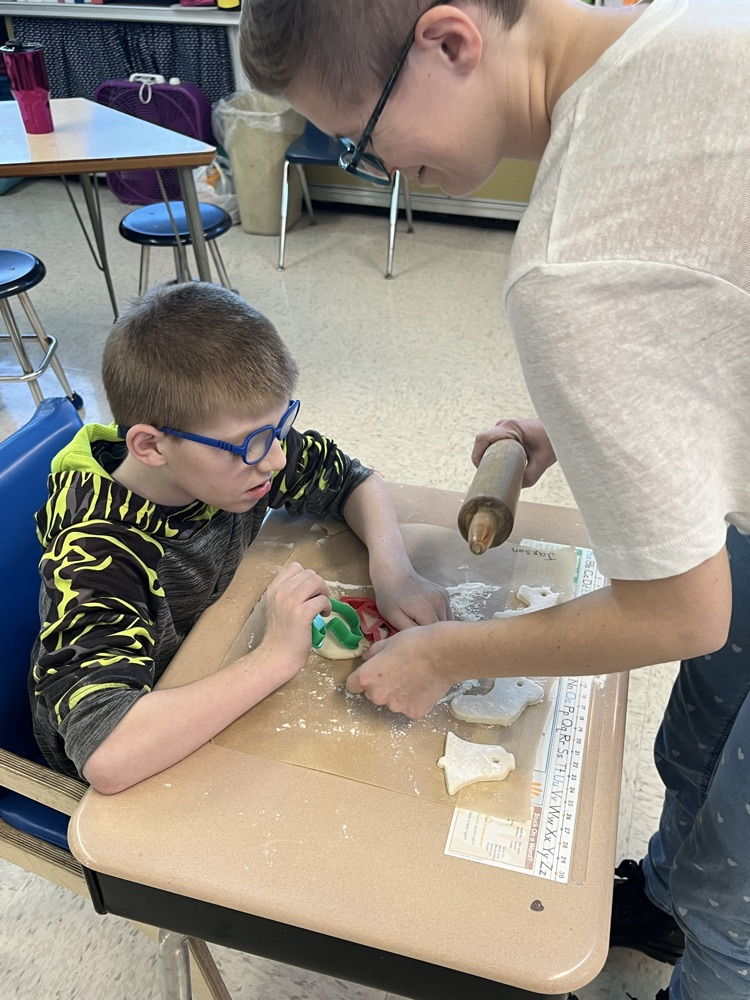 student cutting out shapes