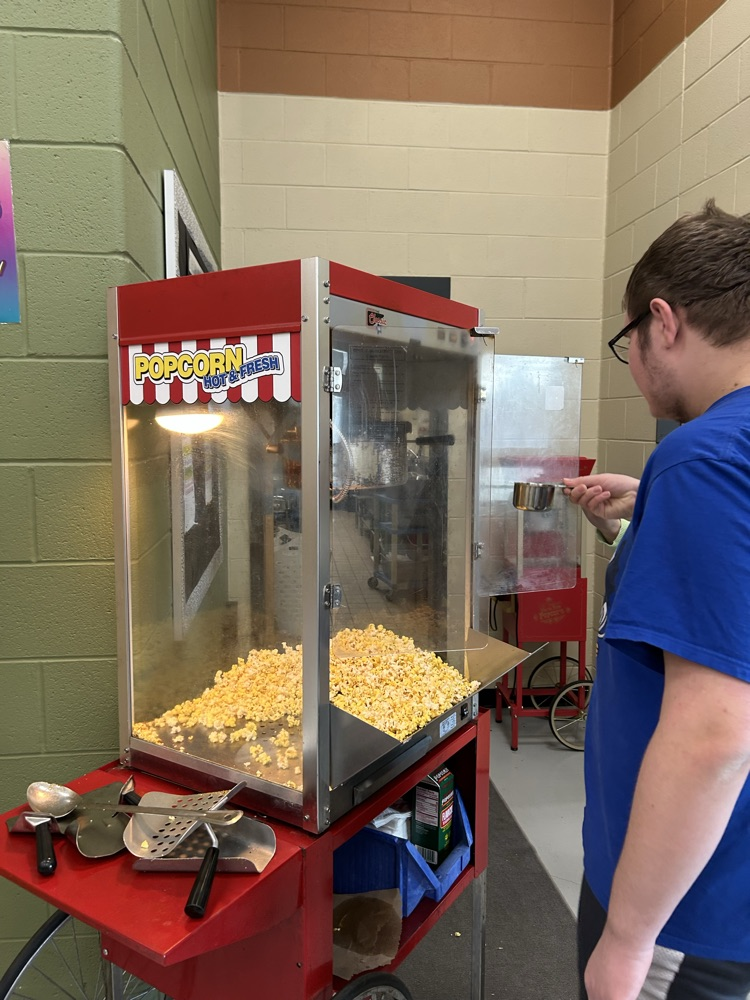 student at popcorn machine